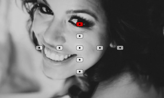 Retrato aproximado de uma mulher olhando em direção à câmera com o ponto de foco superior sobrepondo o seu olho.
