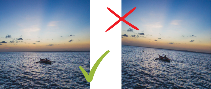 Duas fotos iguais do mar grandioso e uma pessoa remando em uma canoa ao centro. Uma das fotos está com o horizonte nivelado e tem um check verde. A outra está com o horizonte torto e tem um X vermelho.